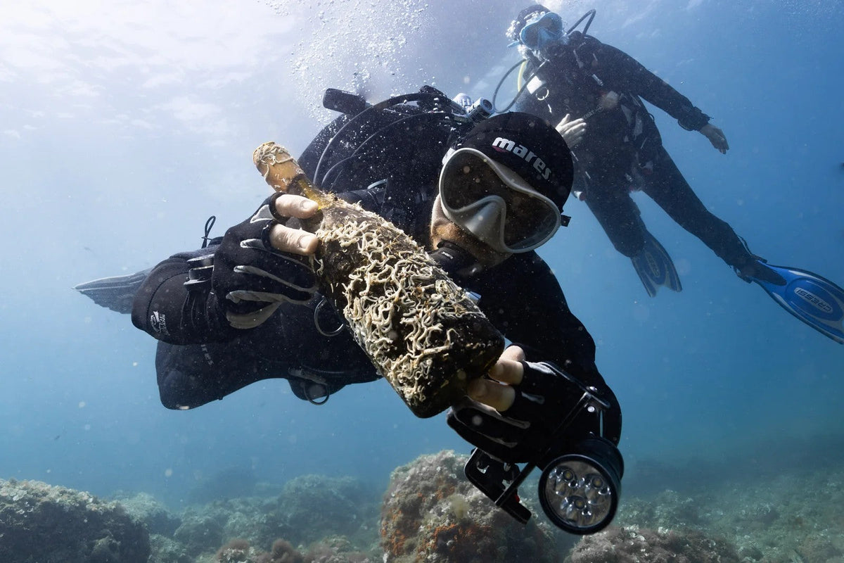 Diver holding a bottle recovered from the sea